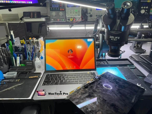 MacBook Pro screen replacement in progress on an ESD-safe bench — MacTech Pro Dubai Marina