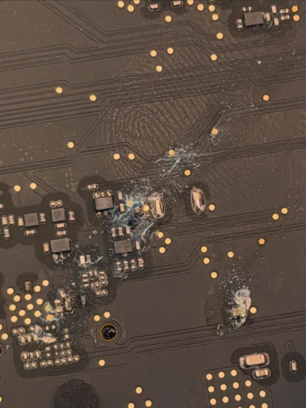 Water-damaged MacBook logic board with corrosion before ultrasonic cleaning in Dubai — MacTech Pro